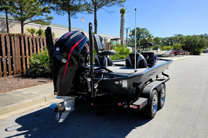 Slide: The Image of 2026 Ranger ALPHA 208 boat on trailer, parked outdoors, featuring powerful outboard motor. - 6