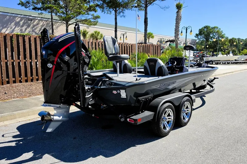 Slide: The Image of 2026 Ranger ALPHA 208 boat on trailer, parked outdoors, featuring sleek design and powerful engine. - 5
