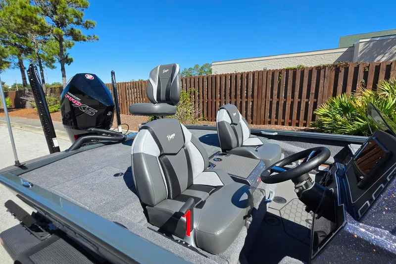 Slide: The Image of 2026 Ranger ALPHA 208 boat interior with modern seating and steering, set against a sunny backdrop. - 18