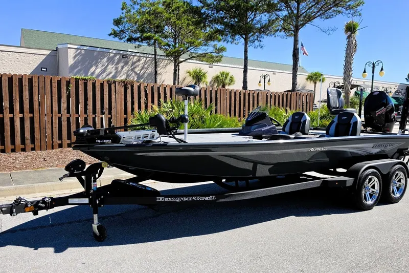 Slide: The Image of 2026 Ranger ALPHA 208 boat on trailer, parked outdoors, with modern design and dual seats. - 12