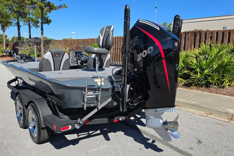 Slide: The Image of 2026 Ranger ALPHA 208 boat with powerful 200 HP engine, parked outdoors. - 14