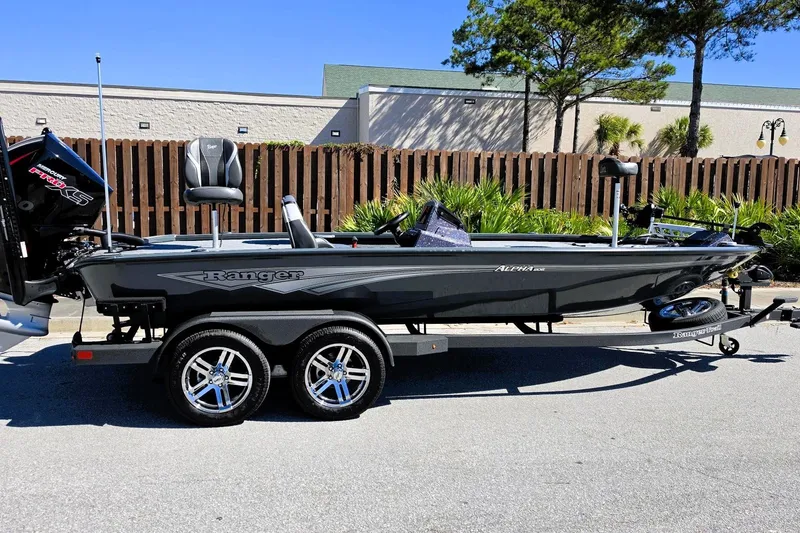 Slide: The Image of 2026 Ranger ALPHA 208 boat on trailer, parked outdoors, featuring sleek design and modern equipment. - 2