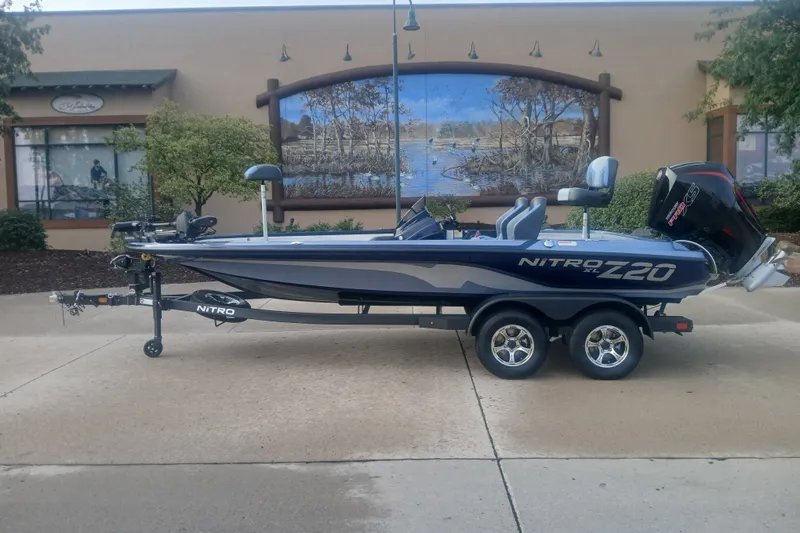 The Image of 2027 Nitro Z20 XL Pro fishing boat on trailer, parked outdoors. - 0