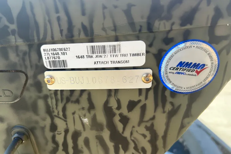 Slide: The Image of 2027 Tracker Grizzly 1648 Utility boat with NMMA certification label and serial number plate. - 23