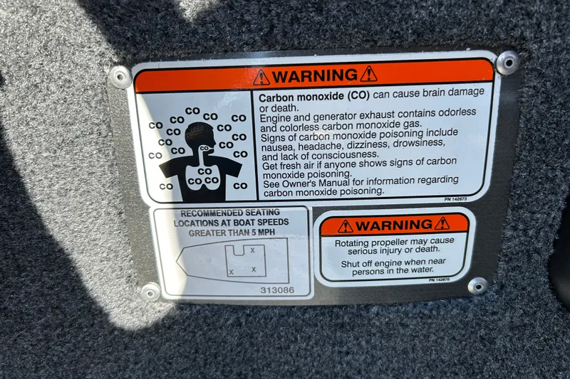Slide: The Image of Warning labels on 2027 Tracker Bass Tracker Classic XL boat, cautioning against carbon monoxide and propeller hazards. - 18