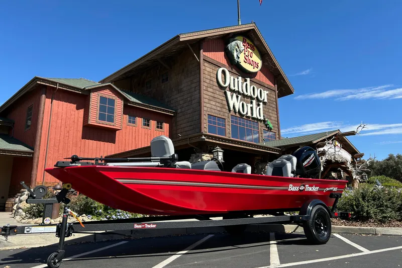 The Image of Red 2027 Tracker Bass Tracker Classic XL boat displayed outside Outdoor World store. - 0