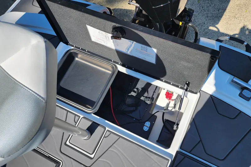 Slide: The Image of 2027 Nitro Z20 XL Pro boat storage compartment with open lid, showcasing interior features and equipment. - 10