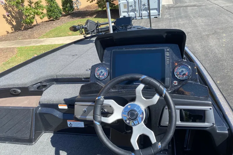 Slide: The Image of Nitro Z20 XL Pro 2027 boat dashboard with steering wheel and digital display. - 2