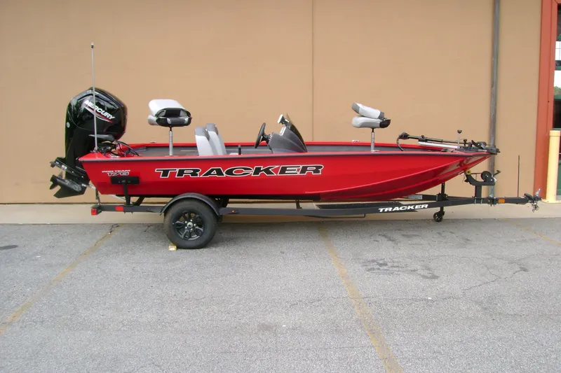The Image of 2027 Tracker Pro Team 175 boat in vibrant red, parked on a trailer. - 0