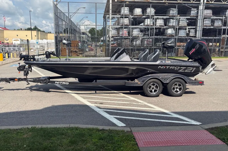 The Image of 2027 Nitro Z21 XL boat on trailer in parking lot, side view. - 0