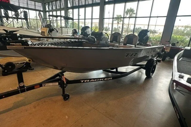 The Image of 2027 Tracker Super Guide V-16 SC boat displayed indoors on a trailer. - 0