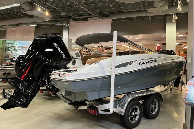 Slide: The Image of 2027 Tahoe 210 S boat on trailer in showroom with Mercury engine. - 4