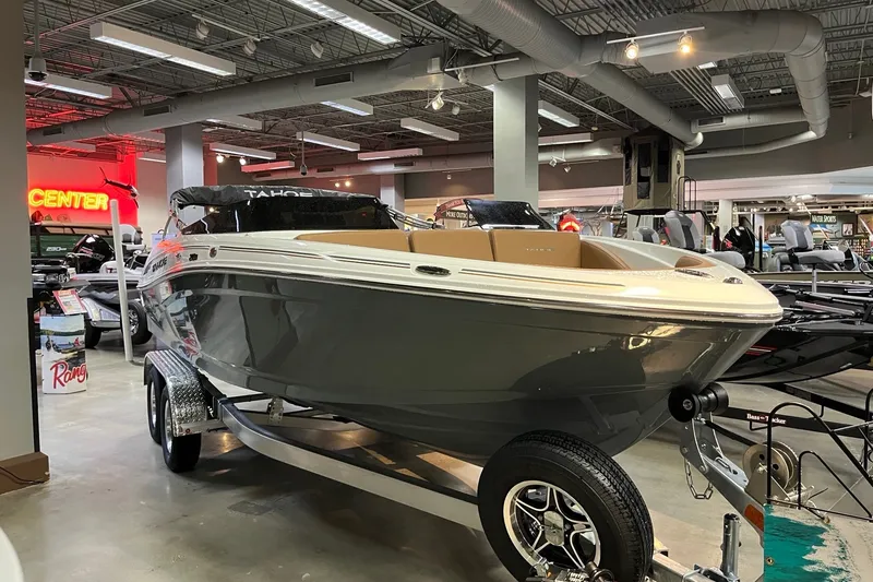 Slide: The Image of 2027 Tahoe 210 S boat displayed indoors on a trailer. - 1