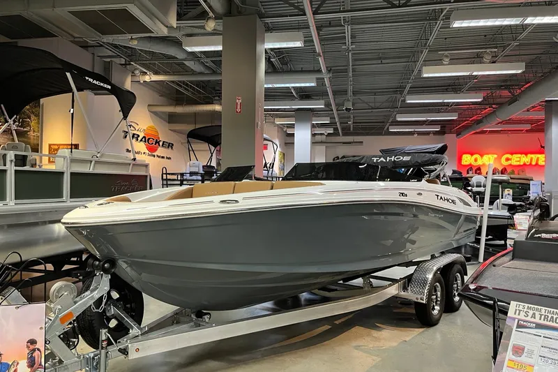 The Image of 2027 Tahoe 210 S boat displayed in a showroom, featuring sleek design and modern amenities. - 0