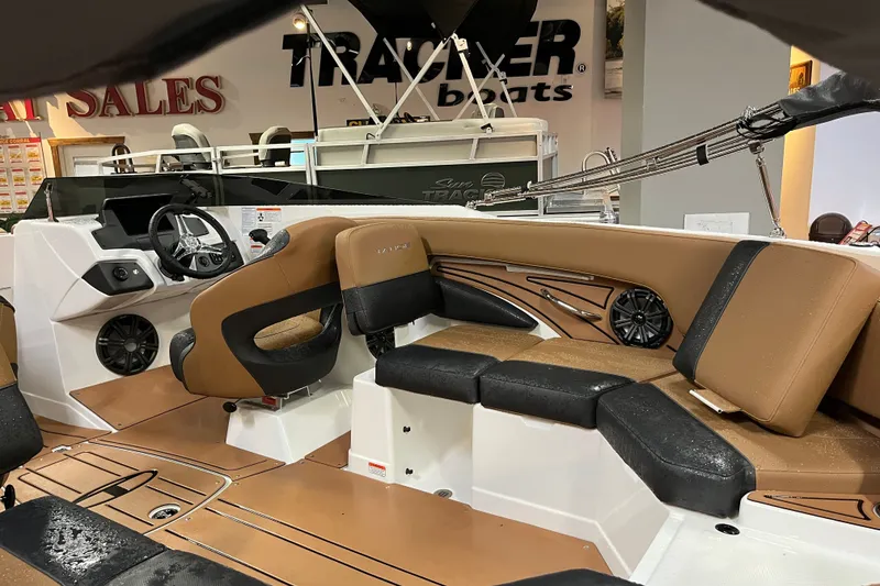 Slide: The Image of Interior of 2027 Tahoe 210 S boat with tan and black seating, steering wheel, and speakers. - 6
