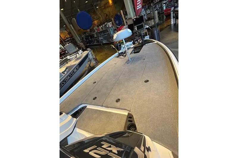 Slide: The Image of 2027 Nitro Z21 XL boat interior with carpeted deck in showroom. - 11