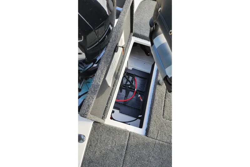 Slide: The Image of Open storage compartment in 2027 Nitro Z18 XL Pro boat, showing battery and wiring. - 61