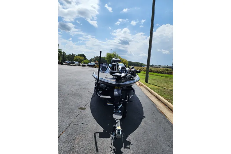 Slide: The Image of 2027 Nitro Z21 XL Pro boat parked on asphalt under a partly cloudy sky. - 3