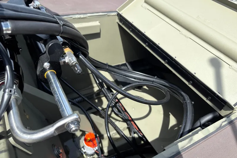 Slide: The Image of Close-up of 2027 Tracker Grizzly 1860 CC boat's steering and wiring components. - 21