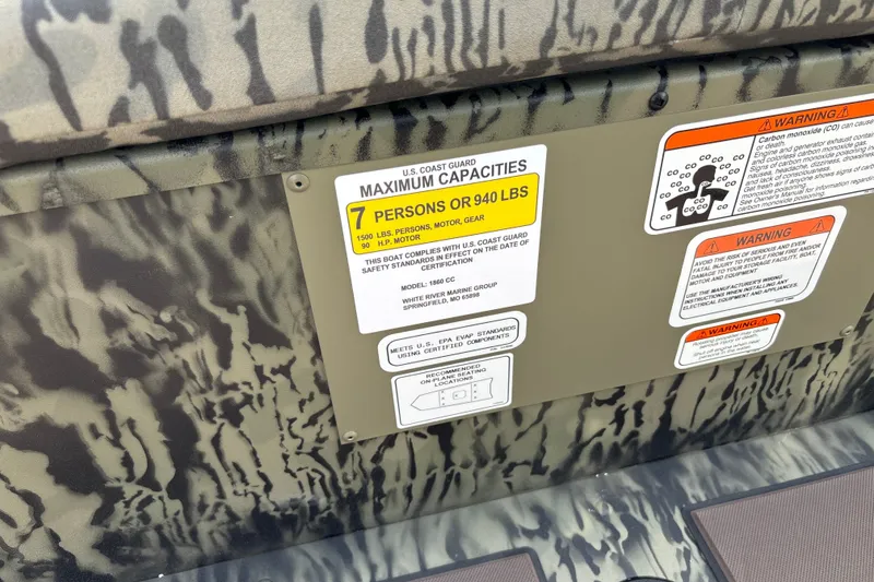 Slide: The Image of 2027 Tracker Grizzly 1860 CC boat capacity and safety warning labels. - 20