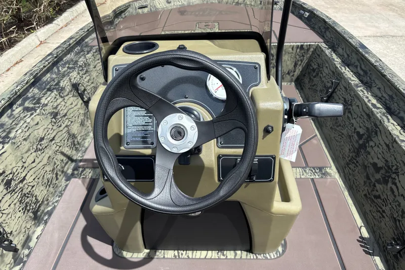 Slide: The Image of Steering console of 2027 Tracker Grizzly 1860 CC boat with camouflage design. - 13