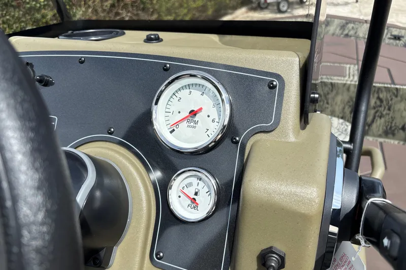 Slide: The Image of Dashboard of 2027 Tracker Grizzly 1860 CC boat showing RPM and fuel gauges. - 14