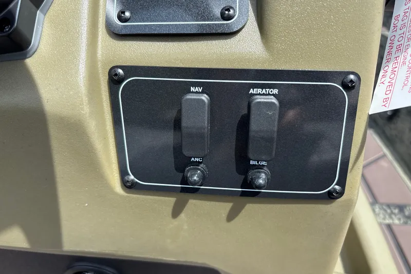 Slide: The Image of Control panel of 2027 Tracker Grizzly 1860 CC boat with navigation and aerator switches. - 15