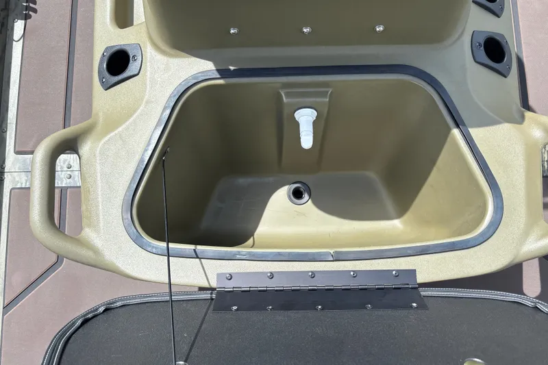 Slide: The Image of Livewell compartment on 2027 Tracker Grizzly 1860 CC boat, featuring rod holders and drainage. - 17