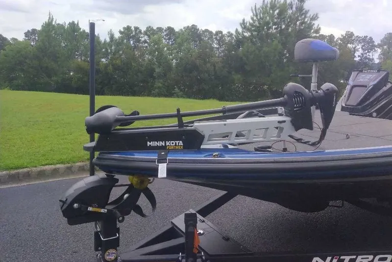Slide: The Image of 2027 Nitro Z21 XL boat with Minn Kota Fortrex trolling motor on a trailer. - 2