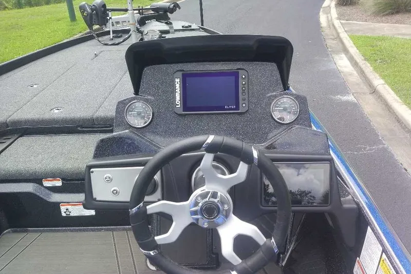 Slide: The Image of 2027 Nitro Z21 XL boat dashboard with steering wheel and Lowrance Elite display. - 4