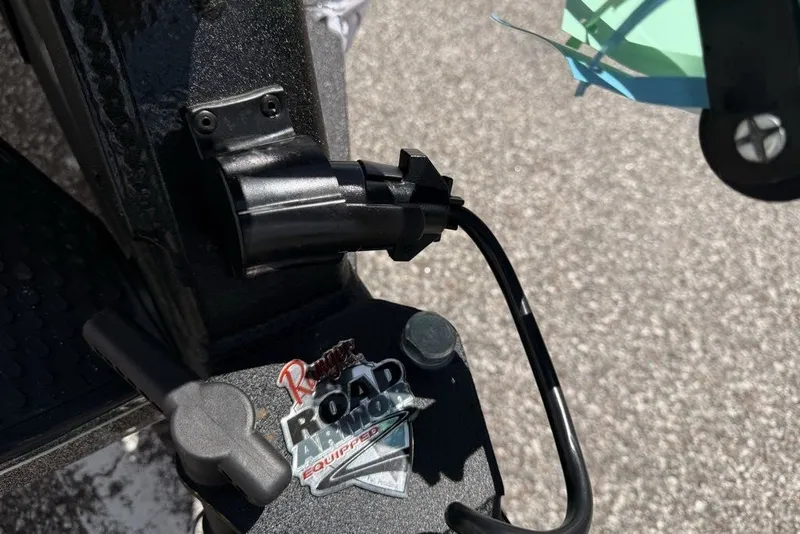 Slide: The Image of Close-up of a 2026 Ranger Z521R Cup-Equipped boat connector and Road Armor badge. - 91