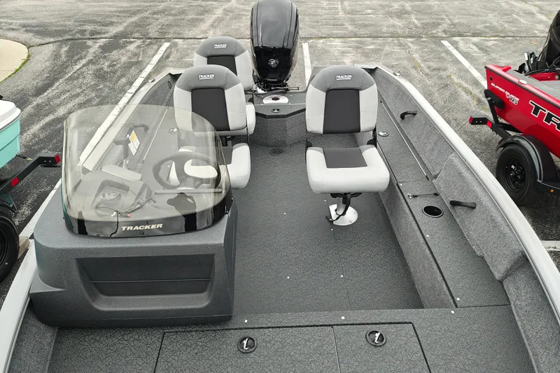 Slide: The Image of 2027 Tracker Pro Guide V-16 SC boat interior with seating and steering console. - 26
