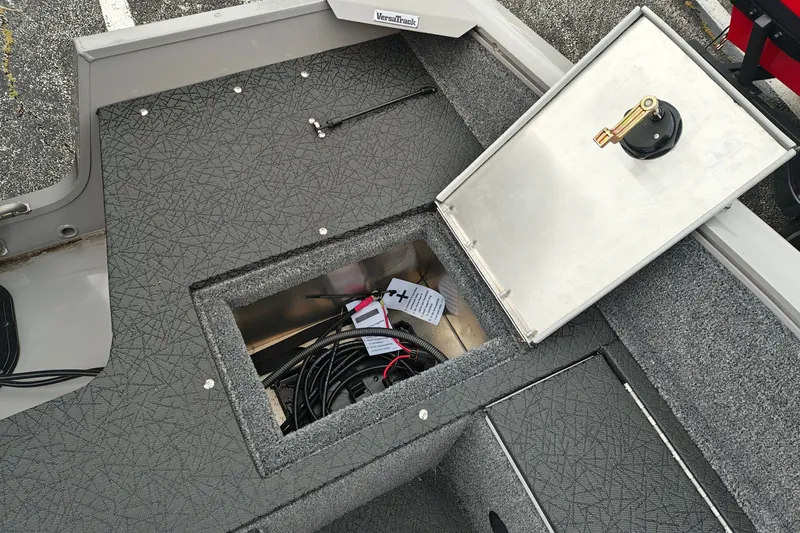 Slide: The Image of Open storage compartment in 2027 Tracker Pro Guide V-16 SC boat, showing cables and equipment. - 29