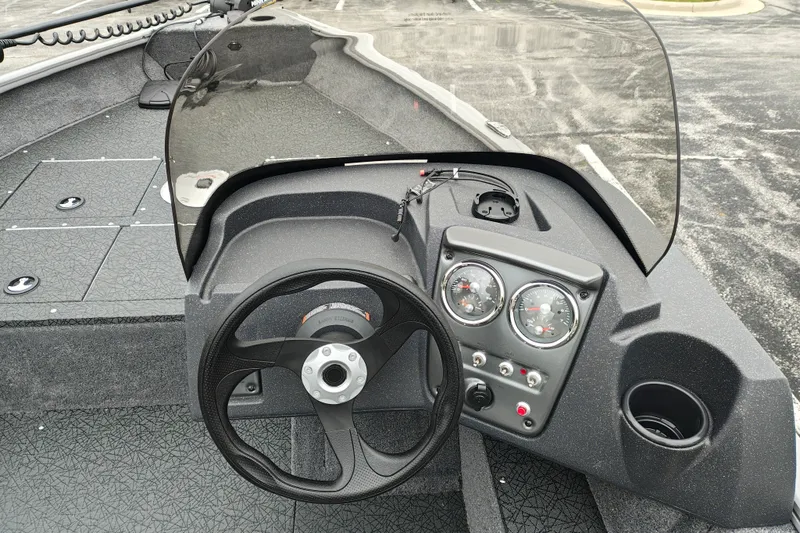Slide: The Image of 2027 Tracker Pro Guide V-16 SC boat dashboard with steering wheel and gauges. - 15