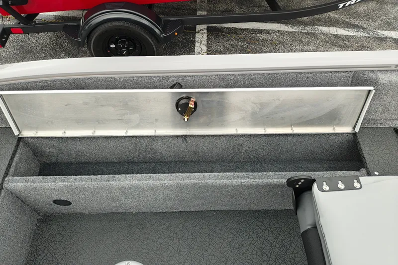 Slide: The Image of 2027 Tracker Pro Guide V-16 SC boat interior with storage compartment and trailer. - 28