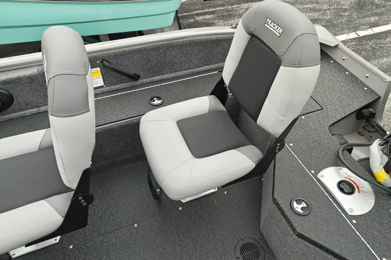 Slide: The Image of 2027 Tracker Pro Guide V-16 SC boat interior with gray seating and textured flooring. - 30