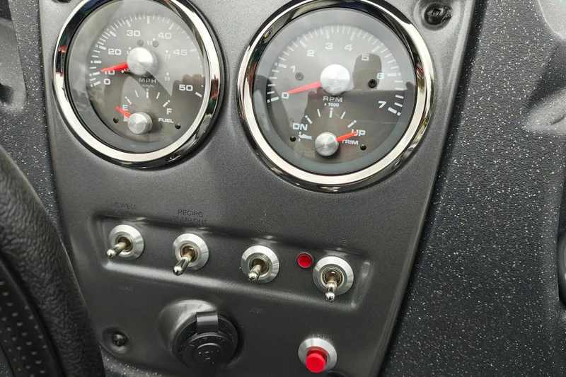 Slide: The Image of Dashboard of 2027 Tracker Pro Guide V-16 SC with gauges and switches. - 16
