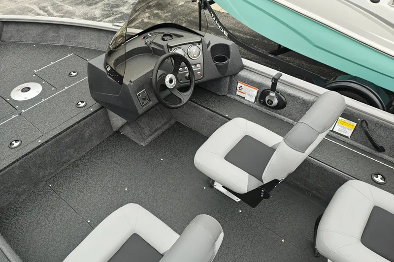 Slide: The Image of 2027 Tracker Pro Guide V-16 SC boat interior with steering console and seating. - 14