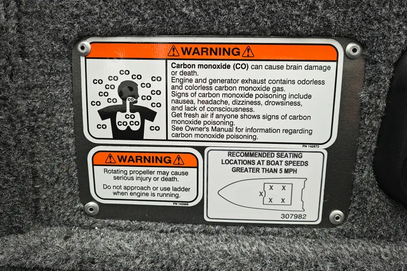 Slide: The Image of Warning labels on 2027 Tracker Pro Guide V-16 SC boat for carbon monoxide and propeller safety. - 18