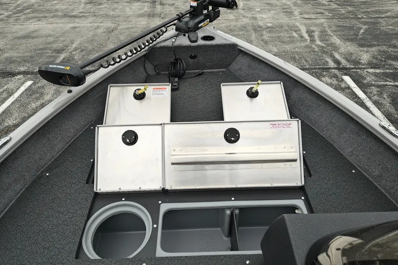 Slide: The Image of 2027 Tracker Pro Guide V-16 SC boat interior with storage compartments and trolling motor. - 21