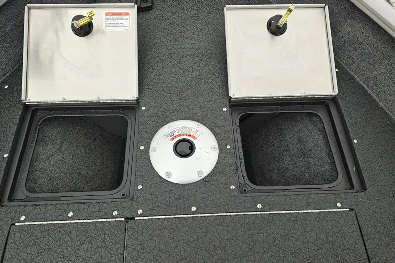 Slide: The Image of 2027 Tracker Pro Guide V-16 SC boat storage compartments with open lids and textured flooring. - 23
