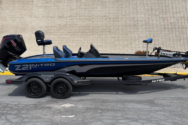 Slide: The Image of 2027 Nitro Z21 XL boat on trailer, sleek design, blue and black color scheme. - 1