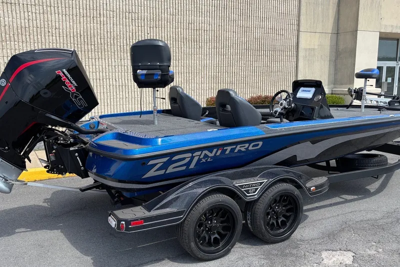 Slide: The Image of 2027 Nitro Z21 XL boat with Mercury Pro XS engine, parked on a trailer. - 3