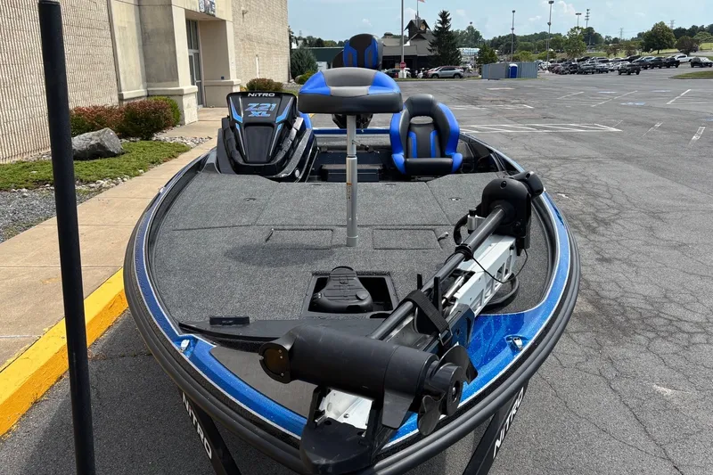 Slide: The Image of 2027 Nitro Z21 XL boat with blue accents parked outdoors. - 4