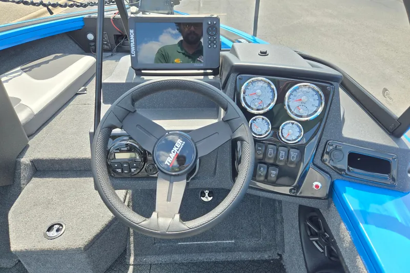 Slide: The Image of 2027 Tracker Targa V-18 Combo boat dashboard with steering wheel and gauges. - 14