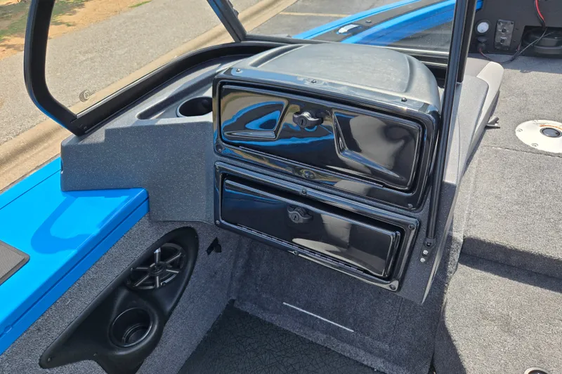 Slide: The Image of 2027 Tracker Targa V-18 Combo boat interior with storage compartments and speaker. - 16