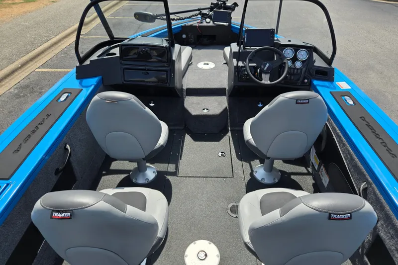 Slide: The Image of 2027 Tracker Targa V-18 Combo boat interior with four gray seats and blue accents. - 13