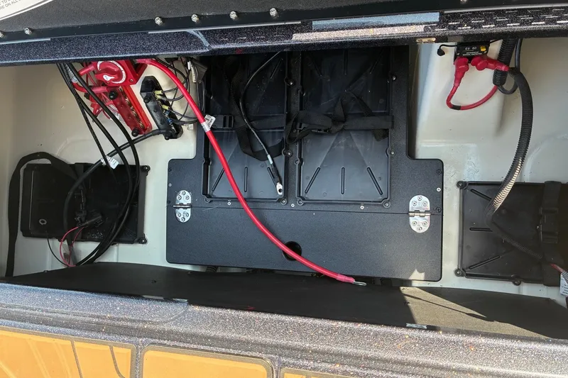 Slide: The Image of Interior view of a 2027 Nitro Z20 XL Pro boat's battery compartment with wiring. - 16