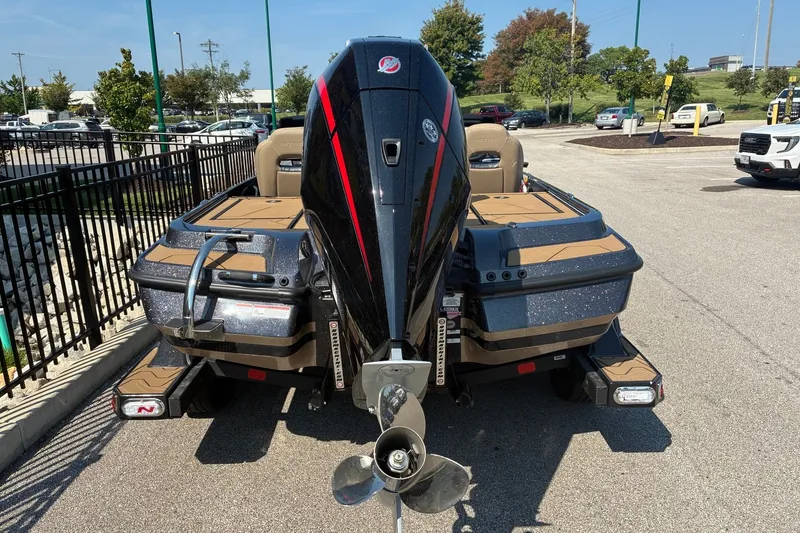 Slide: The Image of 2027 Nitro Z20 XL Pro boat with powerful outboard motor in a parking lot. - 2