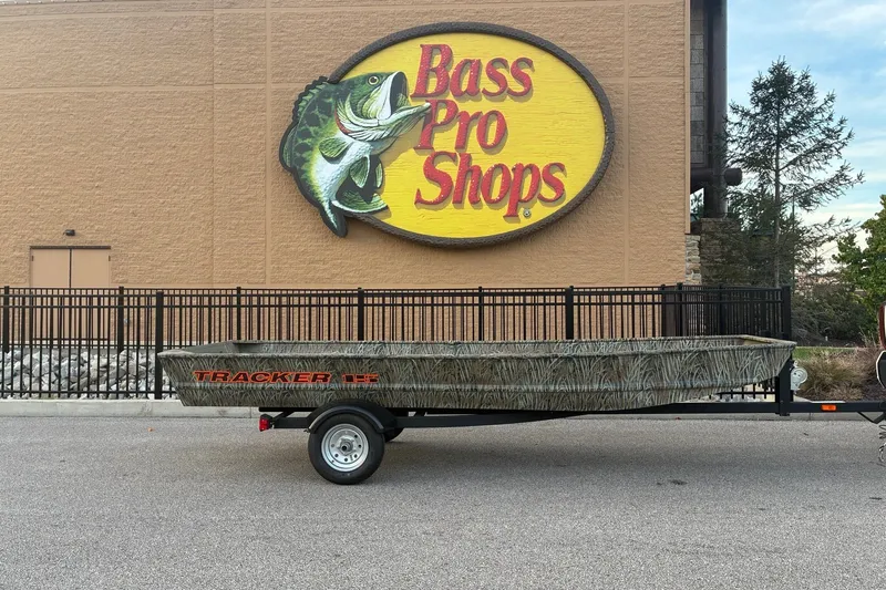 The Image of 2027 Tracker Grizzly 15 Jon boat on trailer outside Bass Pro Shops. - 0